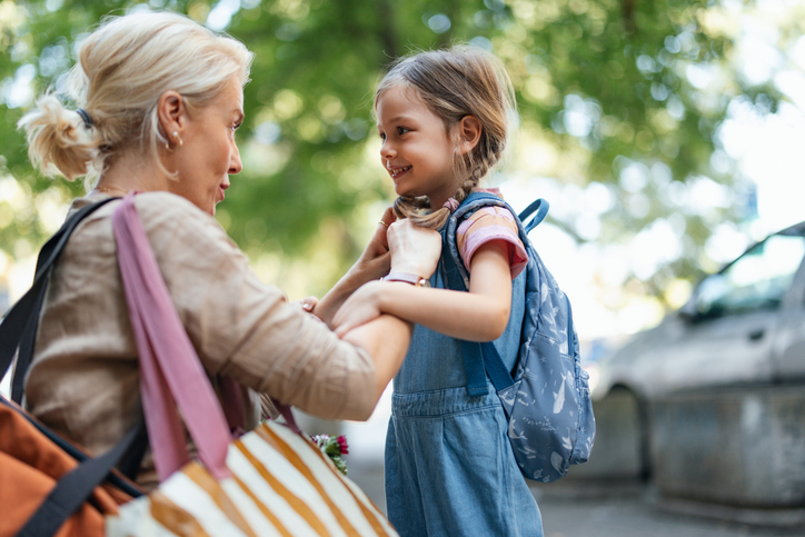 Mother Preparing Daughter for School with a Cheerful Smile in Morning Light